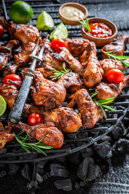 Preview: Closeu of spicy grilled chicken leg on metal grate