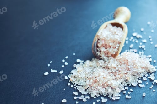 Preview: bowl of pink himalayan salt on dark table, top view, copy space