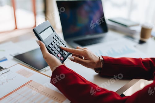 Preview: Beautiful young teen asian businesswoman using computer laptop and calculator for calculate with pl