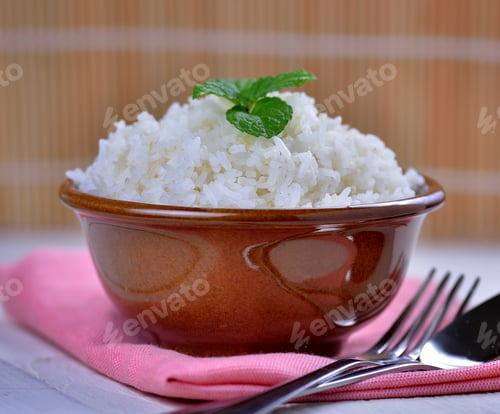 Preview: Cooked white rice garnished with mint in a ceramic bowl