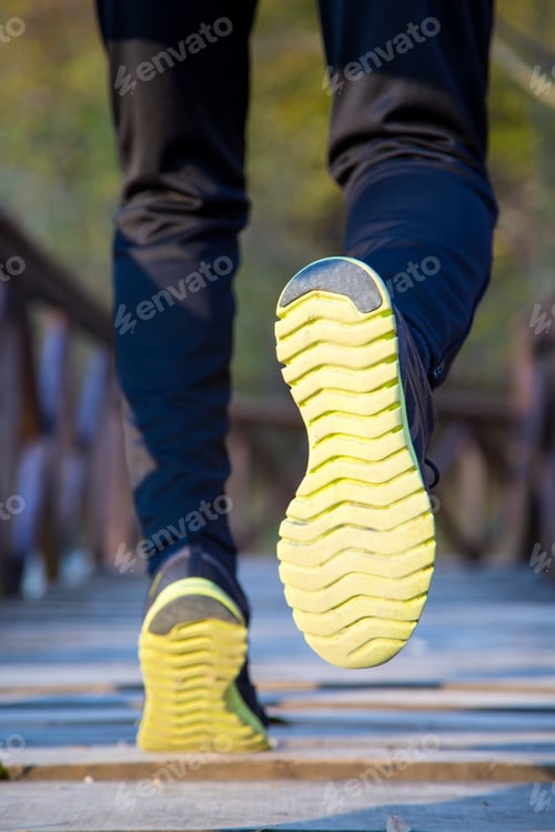 Preview: Runner feet running at park closeup on shoe