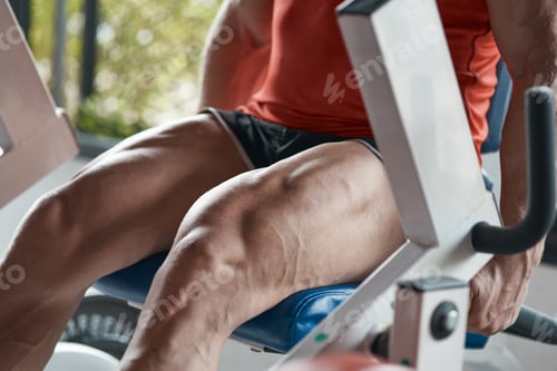 Preview: Close up of strong man sitting on the sport equipment
