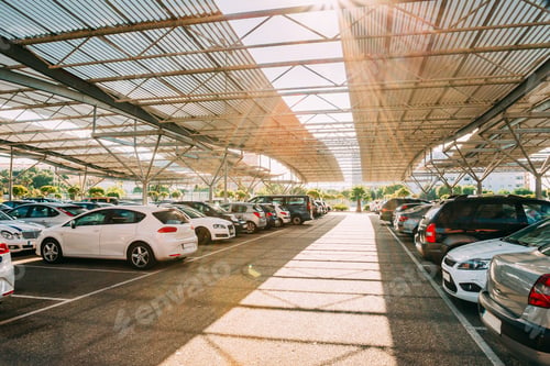 Preview: Cars on a covered parking lot in sunny summer day
