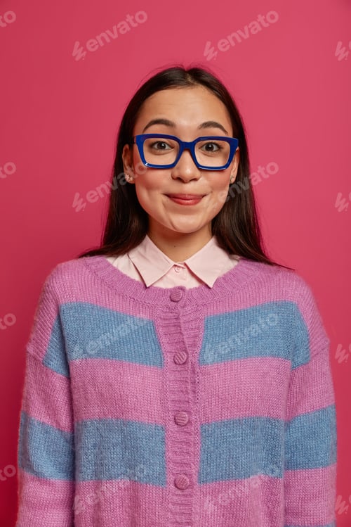 Preview: Satisfied good looking brunette woman with happy face, feels delighted, looks through transparent gl