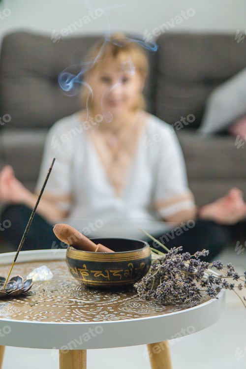 Preview: Woman doing yoga at home and aromatherapy. Selective focus.