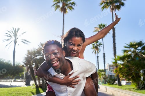 Preview: Cheerful portrait of a young African American couple on their holidays on an island.