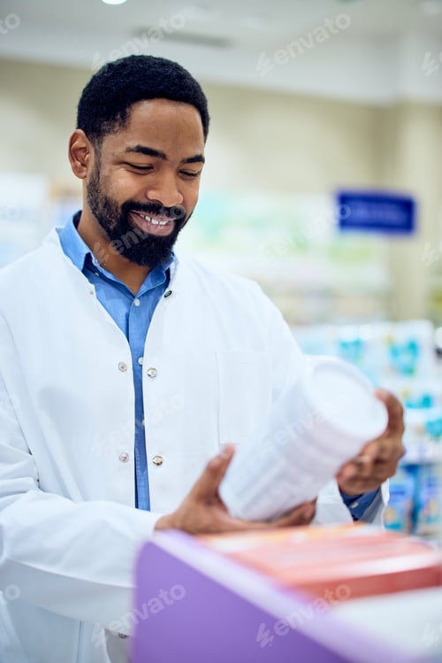 Preview: Pharmacist Reviewing Product Details in a Bright Modern Pharmacy Setting