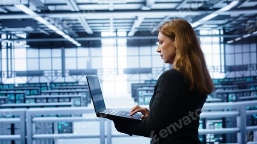 Preview: System administrator in server farm using laptop to patch network issues