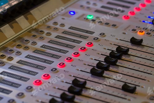 Preview: The buttons, sliders and controls of a studio or sound engineers mixing desk