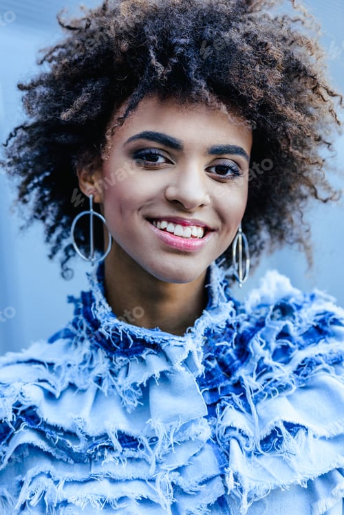 Preview: portrait of smiling african american girl in denim clothes posing for fashion shoot