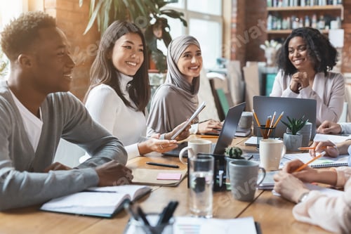 Preview: Close up of young multiracial team having meeting in office