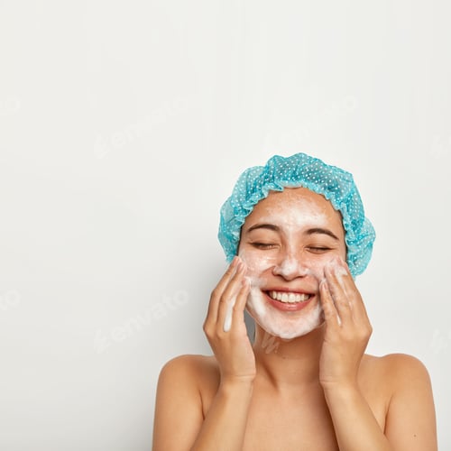 Preview: Flawless and purity of skin. Vertical image of pretty woman washes face, enjoys cold water, has foam