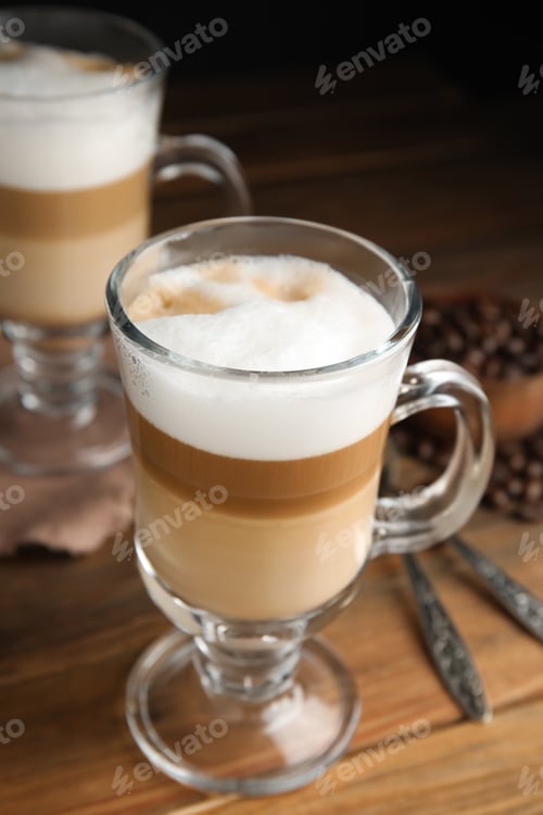 Preview: Delicious latte macchiato and coffee beans on wooden table