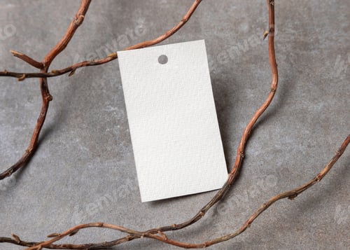 Preview: Blank gift tag mockup on grey stone with dry branches, copy space. Handmade product label