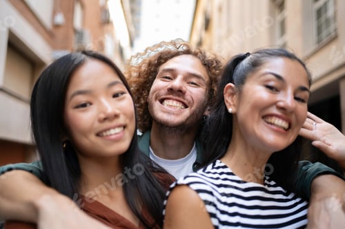 Preview: Selfie if three happy friends embracing in a city street