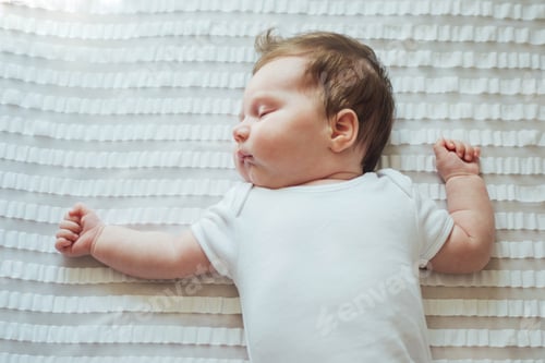 Preview: Cute Infant Sleeping Soundly on White Bedding
