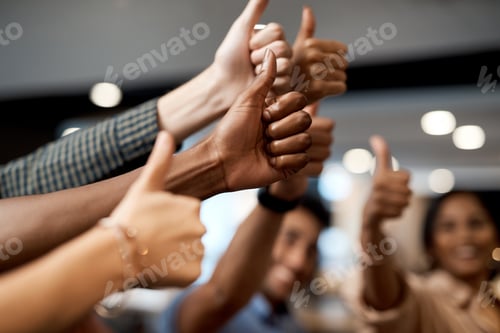 Preview: Shot of a group of unrecognisable businesspeople showing thumbs up in a modern office