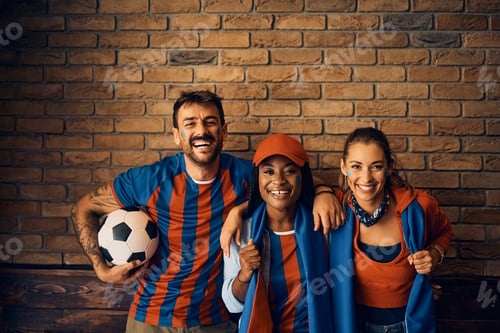 Preview: Multiracial group of cheerful soccer fans looking at camera.