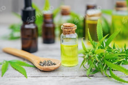 Preview: Cannabis oil in a small bottle. Selective focus.
