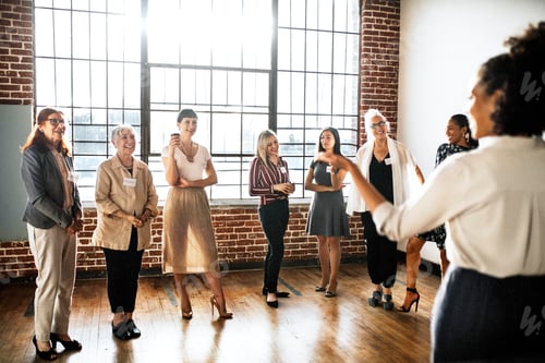 Preview: Young businesswoman talking to a crowd