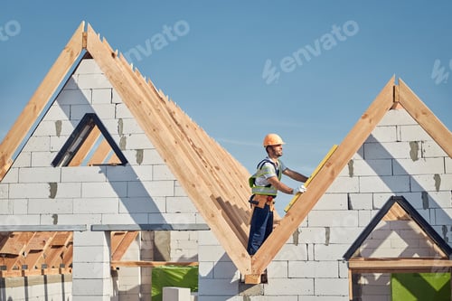 Preview: Professional construction worker standing on top of a building