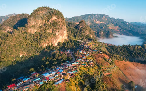 Preview: Colorful traditional village nestled among foggy mountain in countryside at Ban Jabo