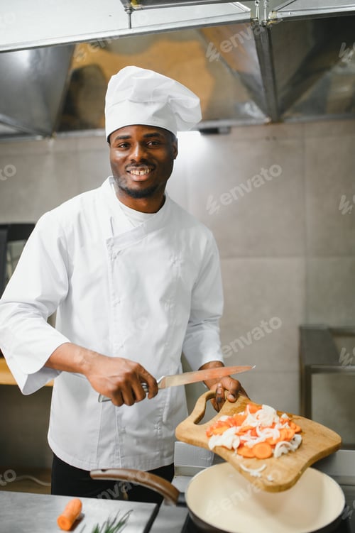 Preview: African American chef cooking tasty salad in kitchen