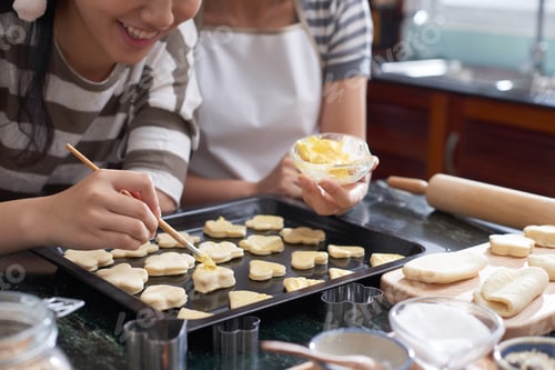 Preview: Women Spreading Butter On Cookies