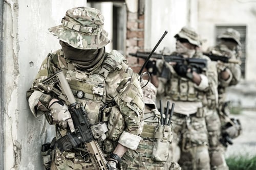 Preview: Soldier in full US MARSOC armed with assault rifle run through the abandoned building. Military