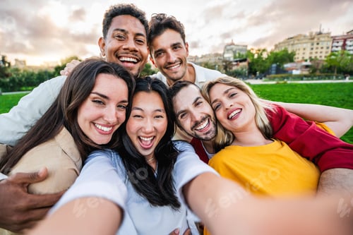 Preview: Multiracial friends smiling at camera outdoors