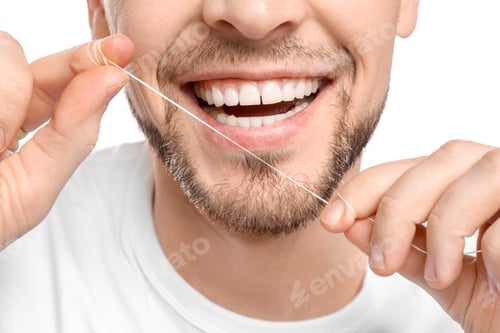 Preview: Young man flossing his teeth on white background