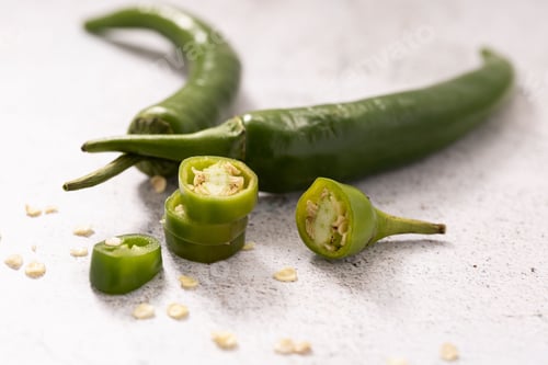 Preview: Closeup of fresh jalapeno peppers on a white table