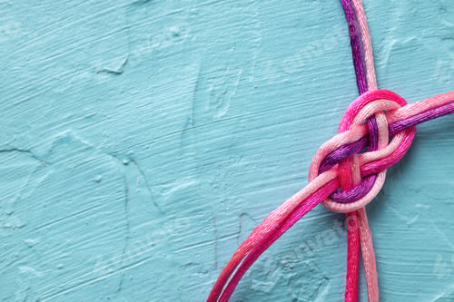 Preview: Braided cords tied together in the shape of an infinity sign on a blue background