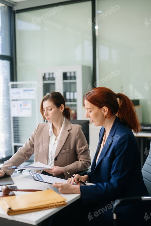 Preview: Professional female lawyers consulting on legal cases in a modern office. Perfect for law, business,