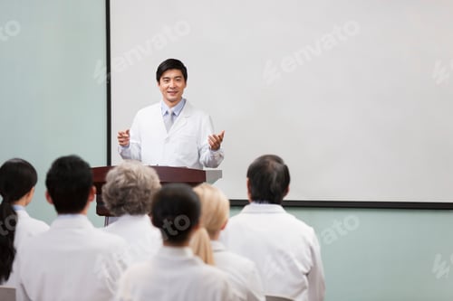 Preview: Male doctor giving speech in boardroom