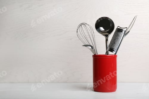 Preview: Holder with clean kitchen utensils on table. Space for text
