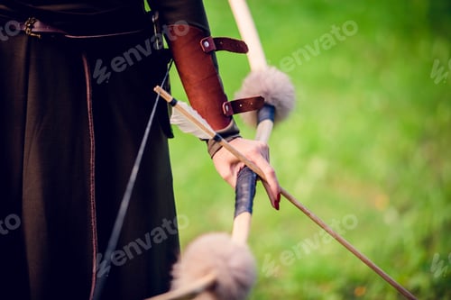 Preview: Close-up, young woman holding a bow and arrow in her hands, art picture