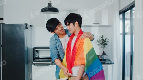 Preview: Asian Gay couple standing and hugging room at home.