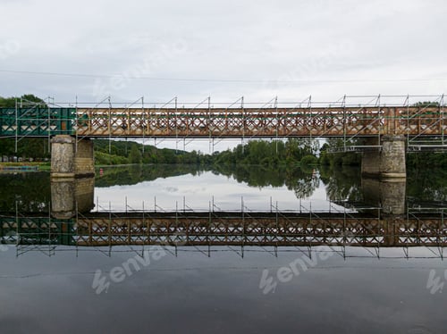 Preview: Scaffolding used for maintenance or restoration work on a small bridge over a large river the Cher