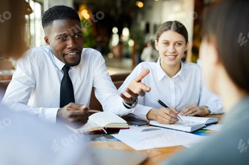 Preview: Business team brainstorming about project in cafe