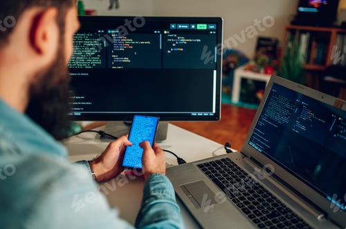 Preview: Operating data security worker reading text on his phone while sitting at home office
