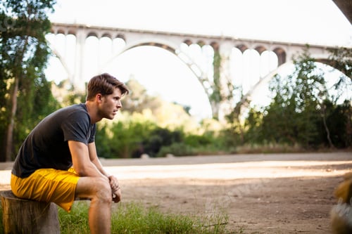 Preview: Jogger taking break, arch bridge in background, Arroyo Seco Park, Pasadena, California, USA