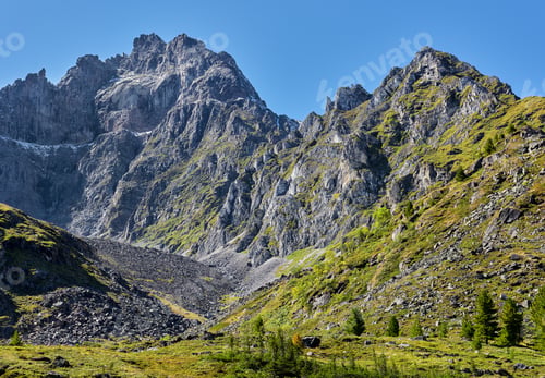 Preview: Collapsing peak with signs of weathering erosion.