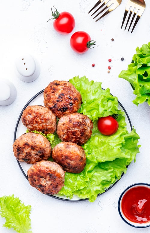 Preview: Homemade fried pork and beef meatballs with green lettuce and tomatoes