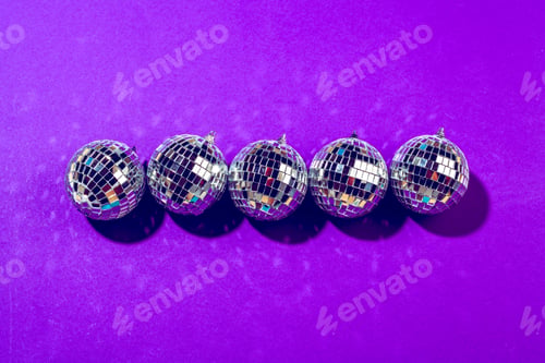 Preview: disco ball shines on purple background close up