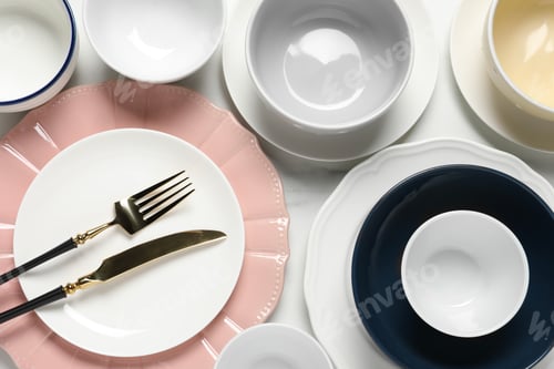 Preview: Beautiful ceramic dishware and cutlery on white table, flat lay