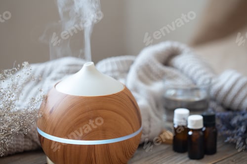 Preview: Composition with an air humidifier and a set of aromatic oils close up.