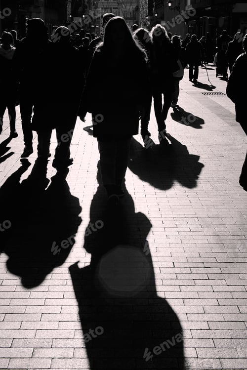 Preview: People walking on the street. Urban crowd in backlight