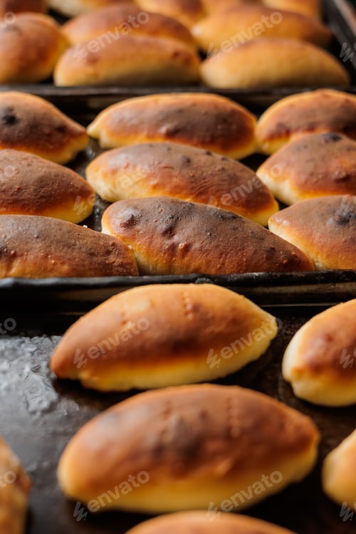 Preview: delicious homemade pastries from the oven. women's hands hold a tray with pies, gluten-free dough