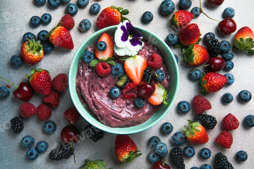 Preview: acai smoothie bowls with strawberries, blueberries, on gray concrete background. Breakfast bowl